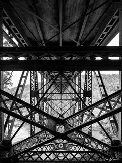 Looking straight across the underside of Deception Pass Bridge. The Iron work looks like a kaleidoscope. 
